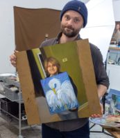 Kristoffer Zetterstrand holding his painting of the picture of Ms. Decker