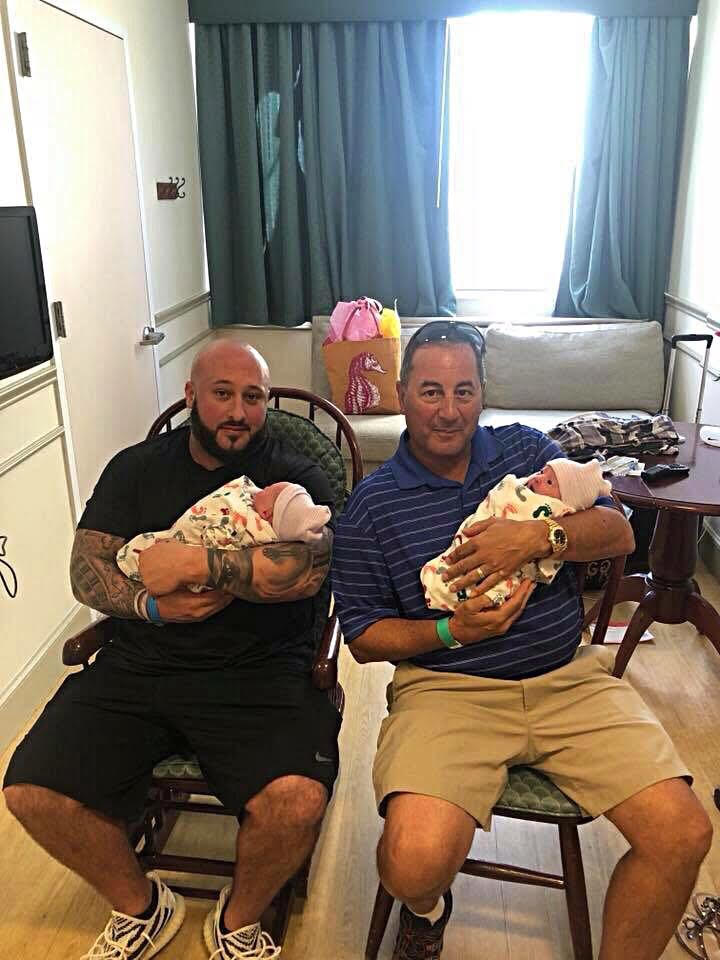 Mr. Ferry (right) and Christopher (left) hold Mr. Ferry's grandchildren.