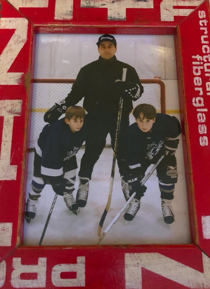 Christopher and Michael Ferry playing hockey with their father, Chris Ferry. Playing jokes on their father is one of the ways the boys show him their love.