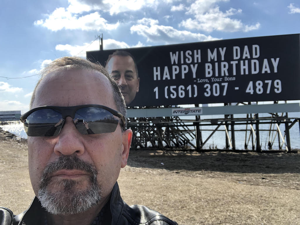 Chris Ferry took this picture of himself in front of the billboard. When this picture was posted to Facebook, people started calling Mr. Ferry from all over the world.