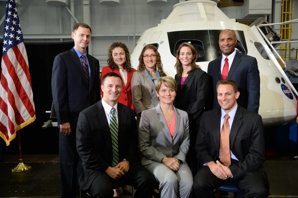 Members of NASA's 2013 astronaut class pose with an Orion capsule at NASA's Johnson Space Center in Houston on Tuesday, Aug. 20, 2013. Pictured back row, left to right: Tyler (Nick) Hague, Jessica Meir, Christina Hammock, Nicole Mann, Victor Glover. Picture front row, left to right: Andrew Morgan, Anne McClain, Josh Cassada.