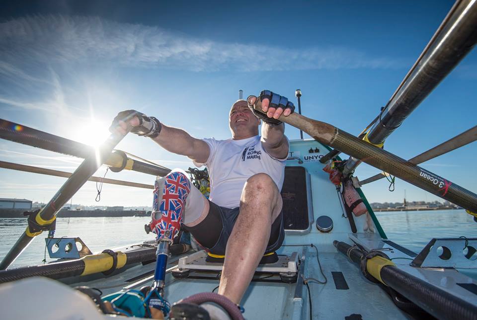 Lee Spencer rowing in his rowboat.