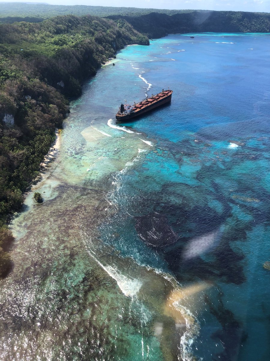 Oil spilling into clear water from Solomon Trader.
