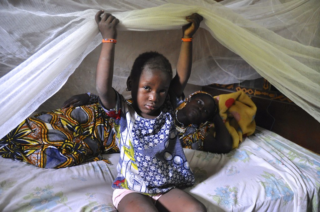 Mother and child under a bednet near Kita, Mali. October 2013. Photographer: Jane Silcock