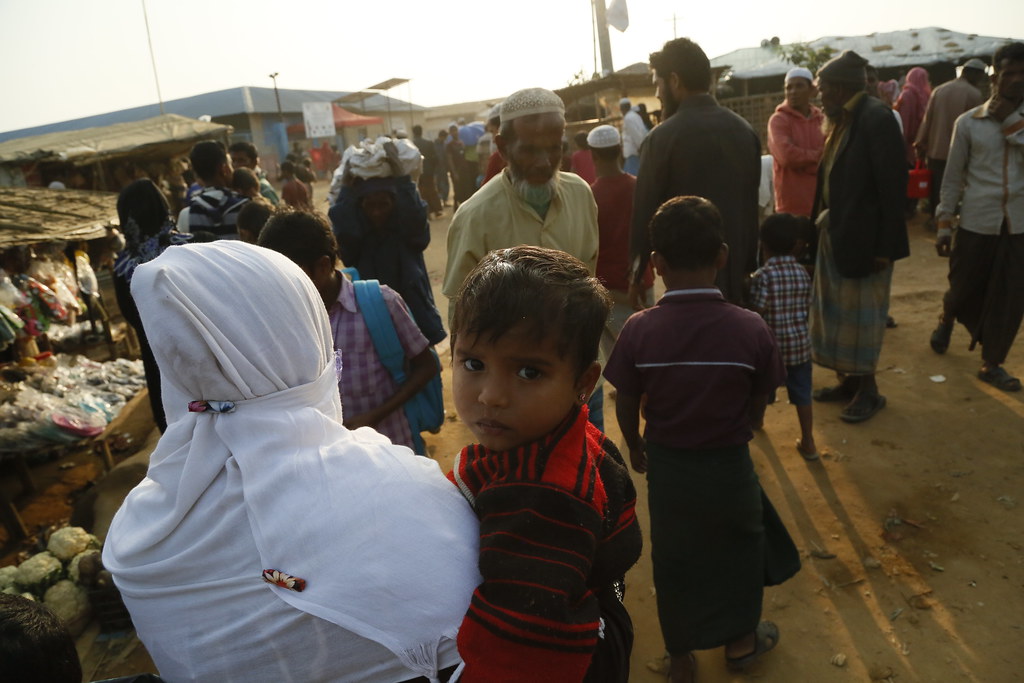 A young child looks anxiously at the camera as his mum takes him to a clinic to be checked for diphtheria in the Kutupalong camp for Rohingya refugees in Bangladesh, January 2018.