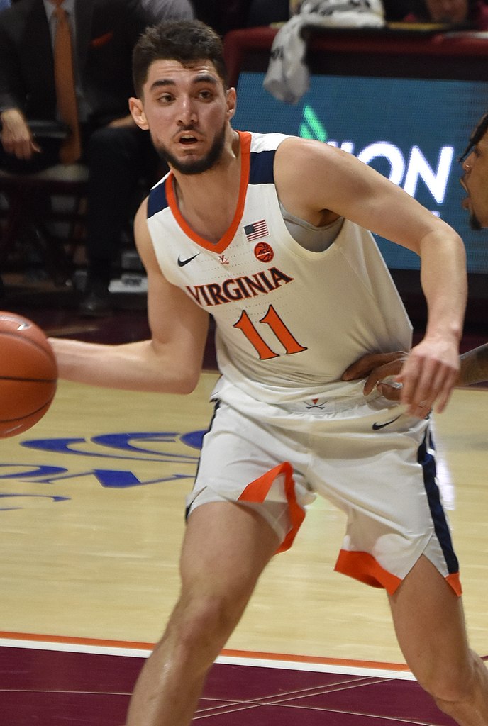 Ty Jerome Handles the ball for the Cavaliers as Ahmed Hill defends