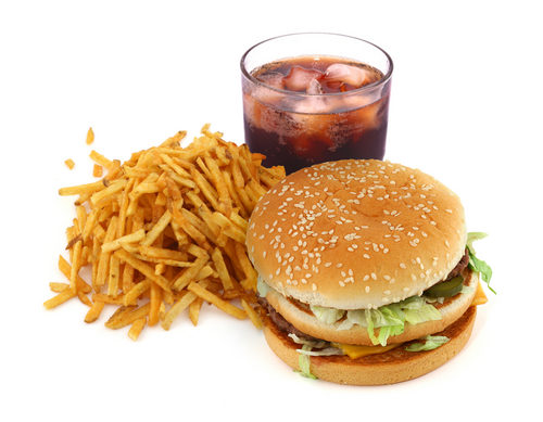 A basic and popular Fast food meal, which includes a burger, french fries and a drink.