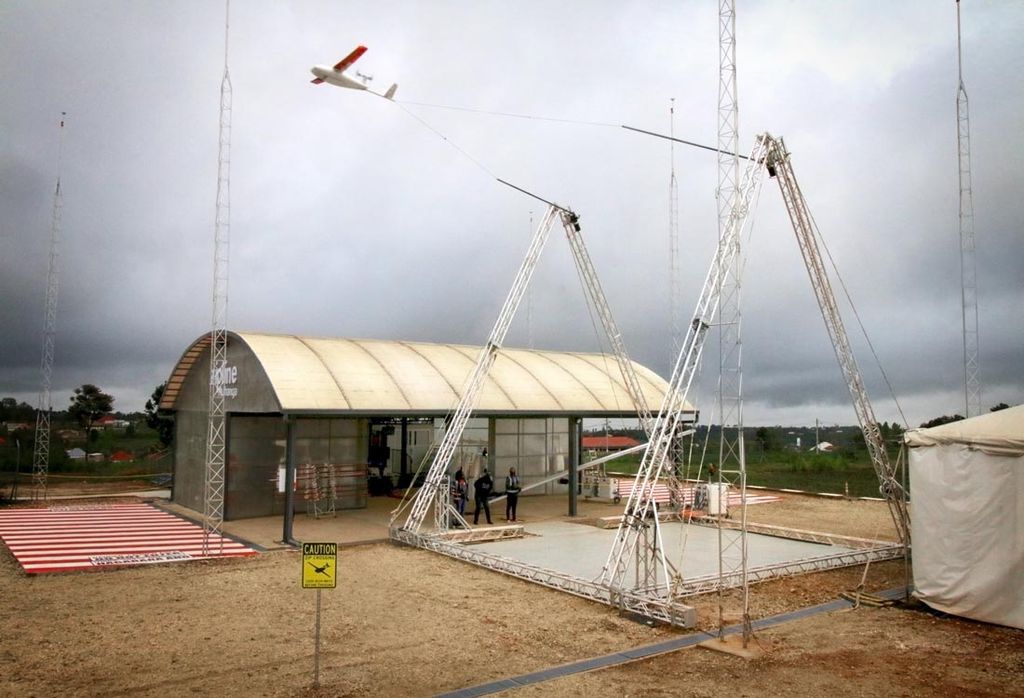 A Zipline drone "lands" by catching its hook on a cable in the air.