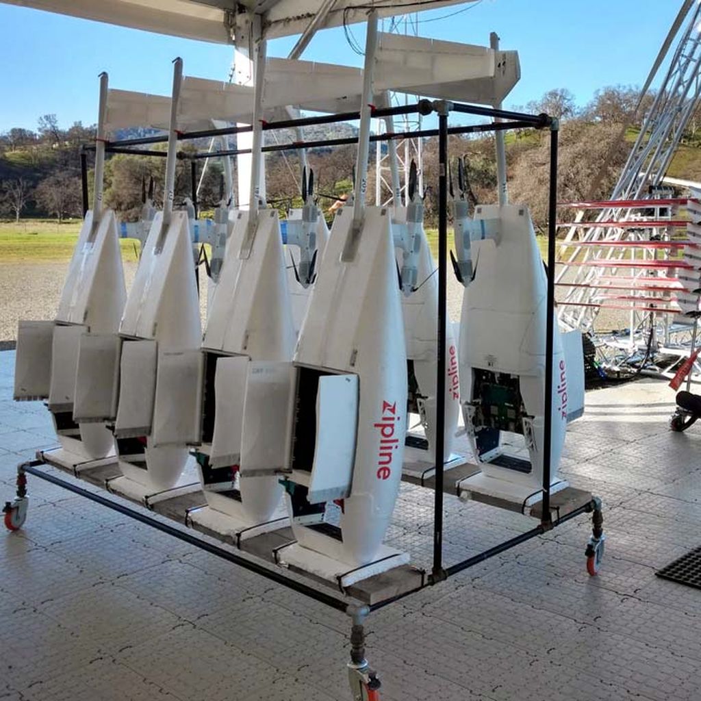 A bank of Zipline drones hang, waiting for action.