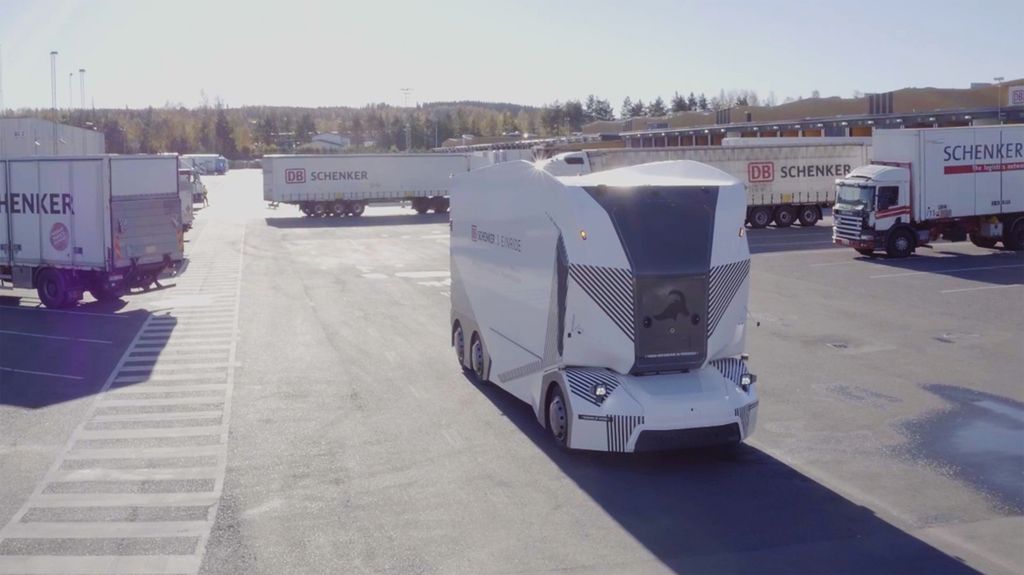 An Einride driverless T-Pod in a parking lot with other trucks.