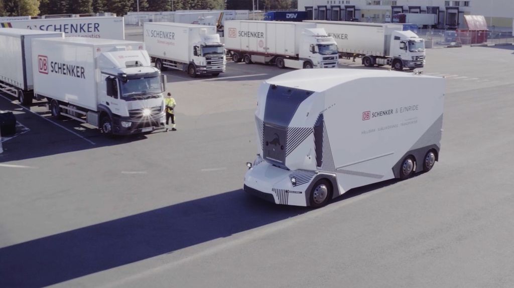 An Einride driverless T-Pod in a parking lot with other trucks.