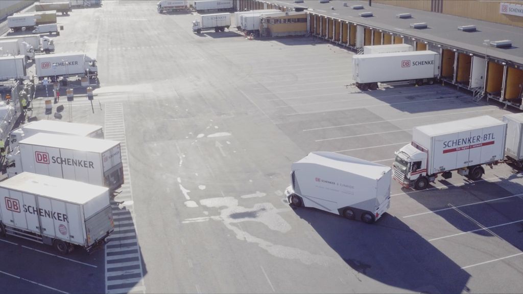 An Einride driverless T-Pod in a parking lot with other trucks.