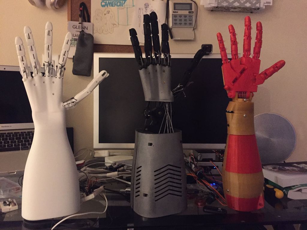 Three versions of Glenn Cameron's robotic hand.