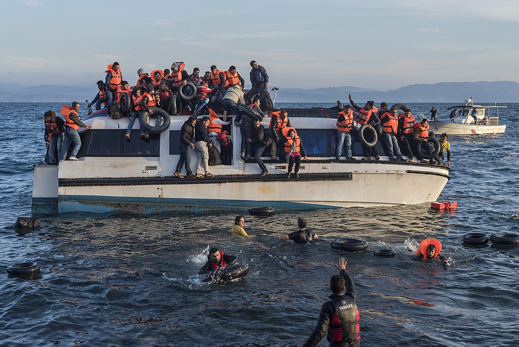 Syrian and Iraqi refugees arrive from Turkey to Skala Sykamias, Lesbos island, Greece. Volunteers (life rescue team - with yellow-red clothes) from the Spanish NGO Proactiva Open Arms help the refugees.