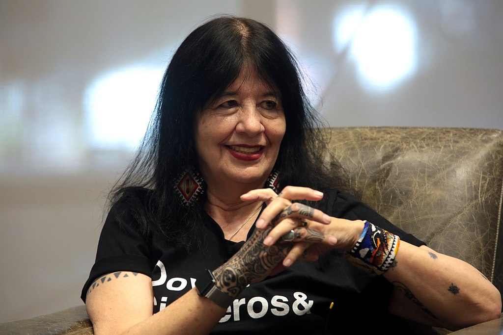 Joy Harjo speaking with attendees at an event titled "Legacies: A Conversation with Sandra Cisneros, Rita Dove and Joy Harjo"