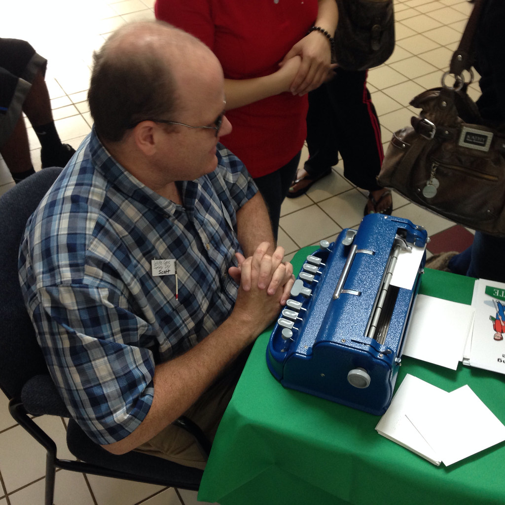 Man at brailler, White Cane Day, USC Upstate