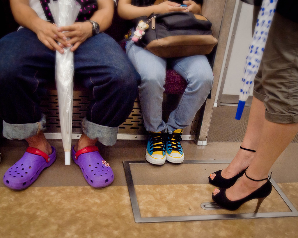 Tokyo Metro Foot Fashions - A small sampling of the wide variety of footwear sitting side by side on the Tokyo subways.