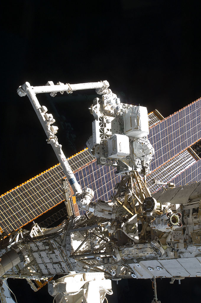 The Canadarm2 or the Space Station Remote Manipulator System mates the Express Logistics Carrier (ELC) 2 to the Zenith / Outboard Payload Attachment System (PAS) on the S3 Truss aboard the International Space Station, as controlled by Atlantis and station crews in the shirt sleeve environment of the orbital outpost.