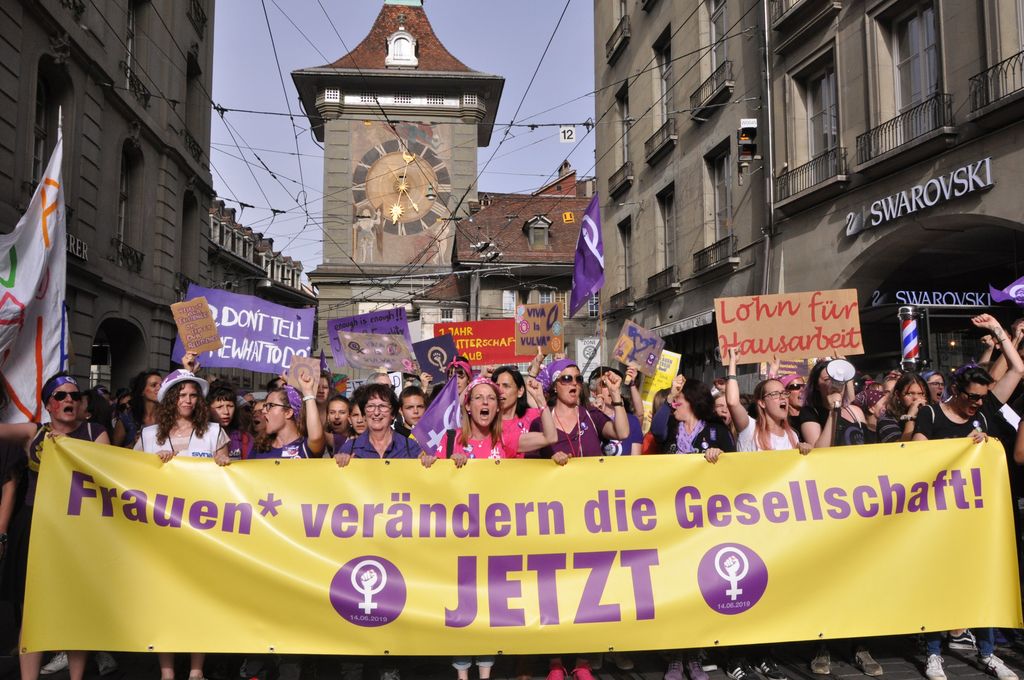 Women marching with signs in the June 14 Women's Strike in Switzerland.