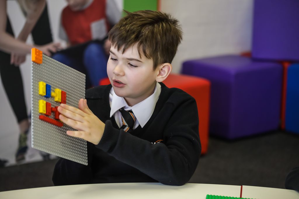 A student works with Lego's Braille bricks to learn math.