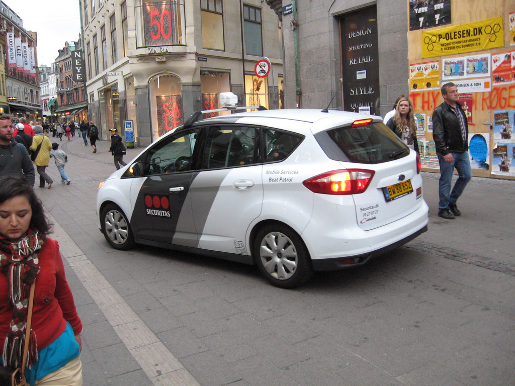 private security vehicle near pedestrians