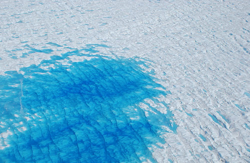 Greenland melt pond. Widespread melting at low altitudes can create small ponds of melt water, particularly at the perimeter of the ice sheet. Around the border of the pond, smaller collections of melt water are seen between ridges of ice. CREDIT: Michael Studinger, NASA GSFC, 2008.