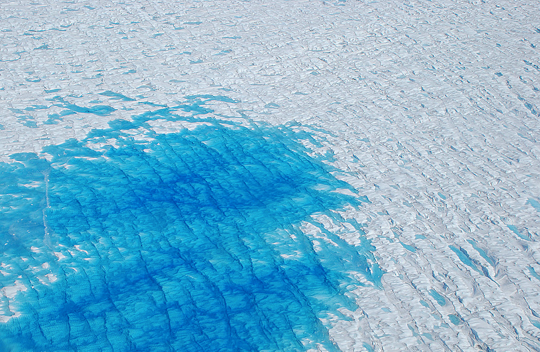 Greenland melt pond. Widespread melting at low altitudes can create small ponds of melt water, particularly at the perimeter of the ice sheet. Around the border of the pond, smaller collections of melt water are seen between ridges of ice. CREDIT: Michael Studinger, NASA GSFC, 2008.