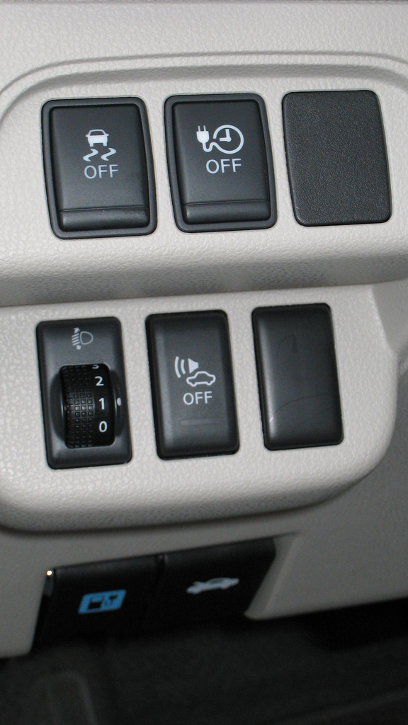 Nissan Leaf control panel showing the warning sound switch. The middle button on the bottom can turn OFF the artificial digital sound the car makes (a faint whirrr) when the Leaf is traveling under 20 MPH to alert pedestrians, the blind, and others of its presence.