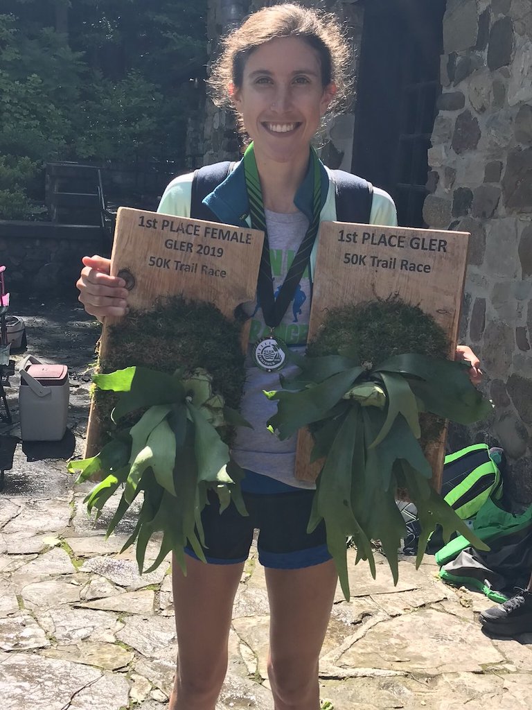 Ellie Pell poses with two trophies - one for 1st place, the other for 1st place female.