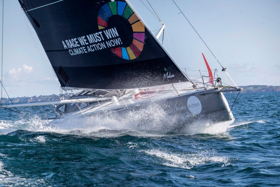 The racing yacht Malizia II with a sail saying "A race we must win - climate action now!"