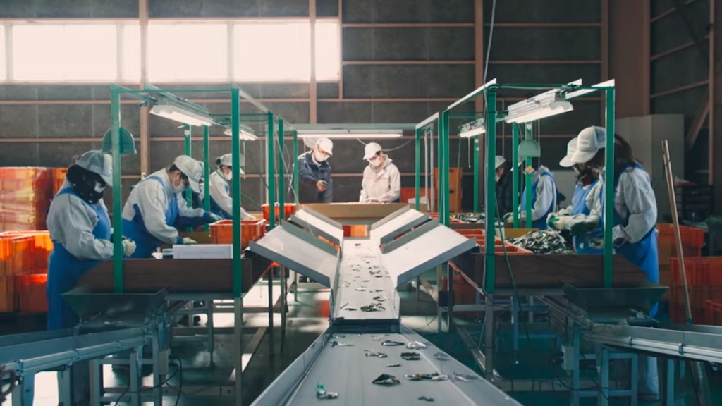 Workers sorting shredded electronic devices