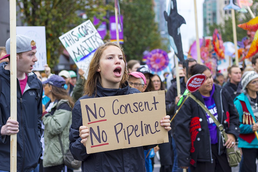 Protester holding sign stating No Pipeline, No Consent, during a Kinder Morgan Pipeline Rally on September 9th, 2017 in Vancouver, Canada.