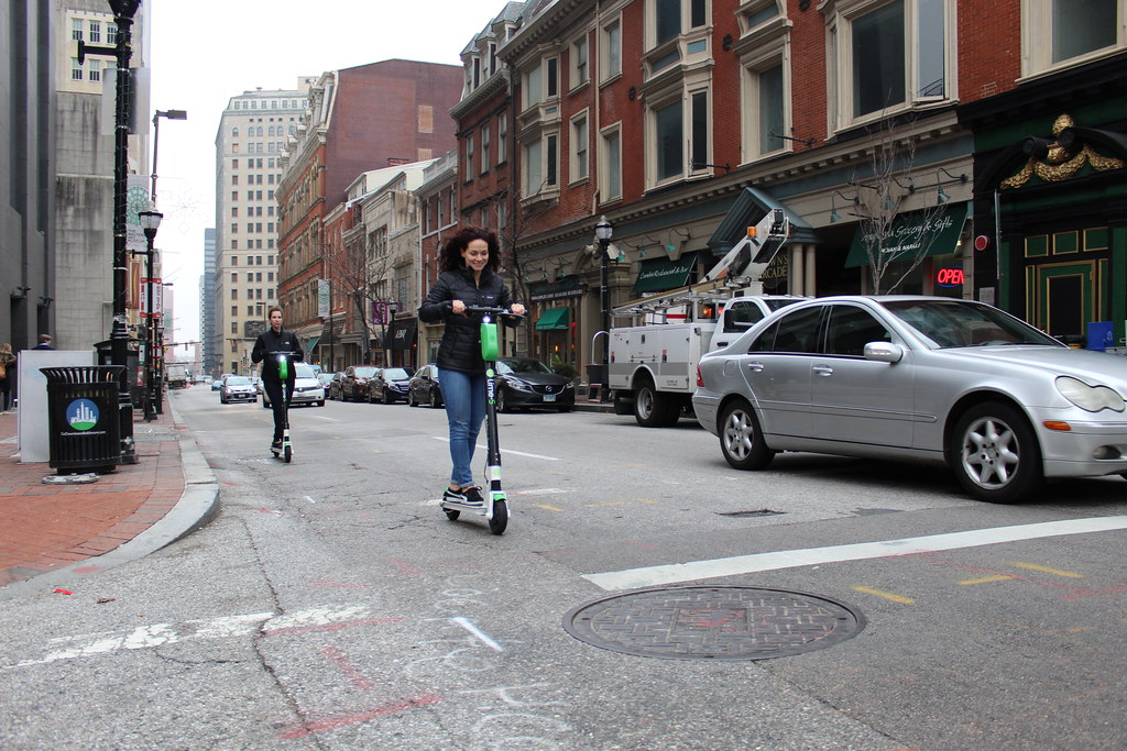 LIME Electric Scooter Rider in the 300 block of North Charles Street in Baltimore MD on Friday afternoon, 14 December 2018 by Elvert Barnes Photography