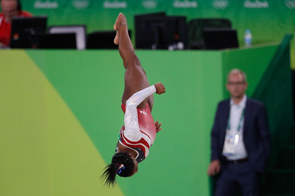 Simone Biles caught upside down during a routine that won a gold medal at the 2016 Olympics in Rio de Janeiro.