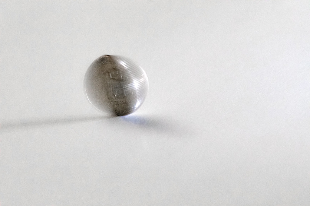 Heads or tails? A coin spinning on a table.