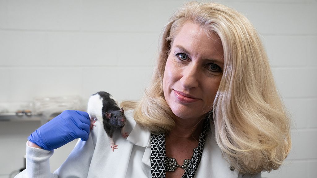 Dr. Kelly Lambert with a rat on her shoulder.