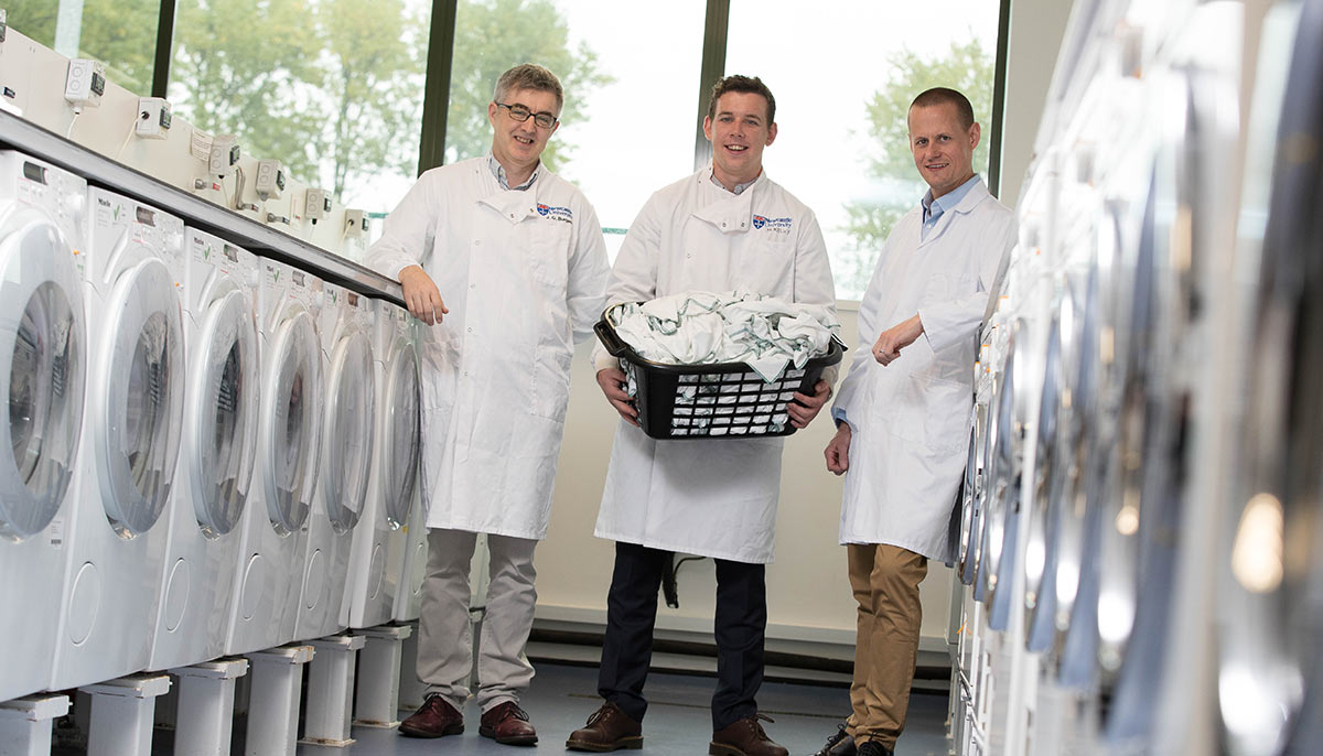 Grant Burgess, Max Kelly, and Neil Lant in the washing machine laboratory.