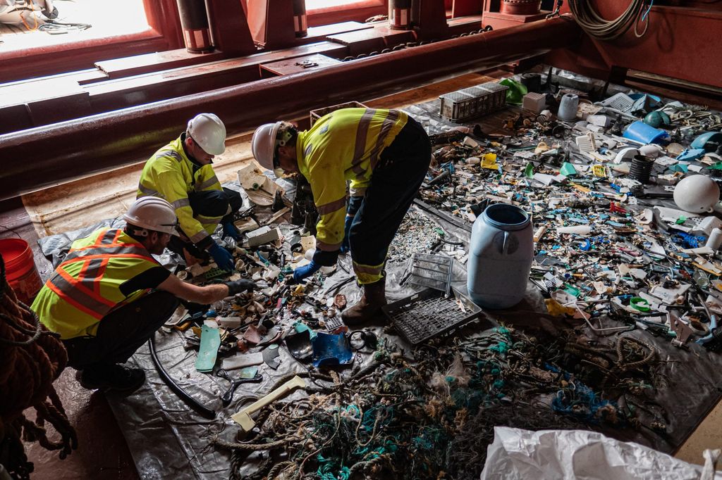 Workers sort through plastic collected by the Ocean Cleanup's System 001/B