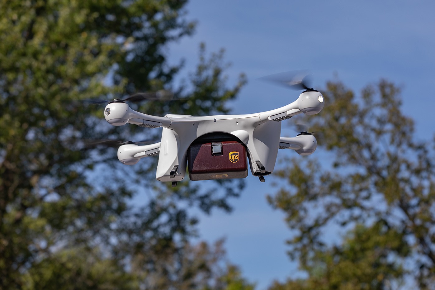 Drone carrying UPS package.