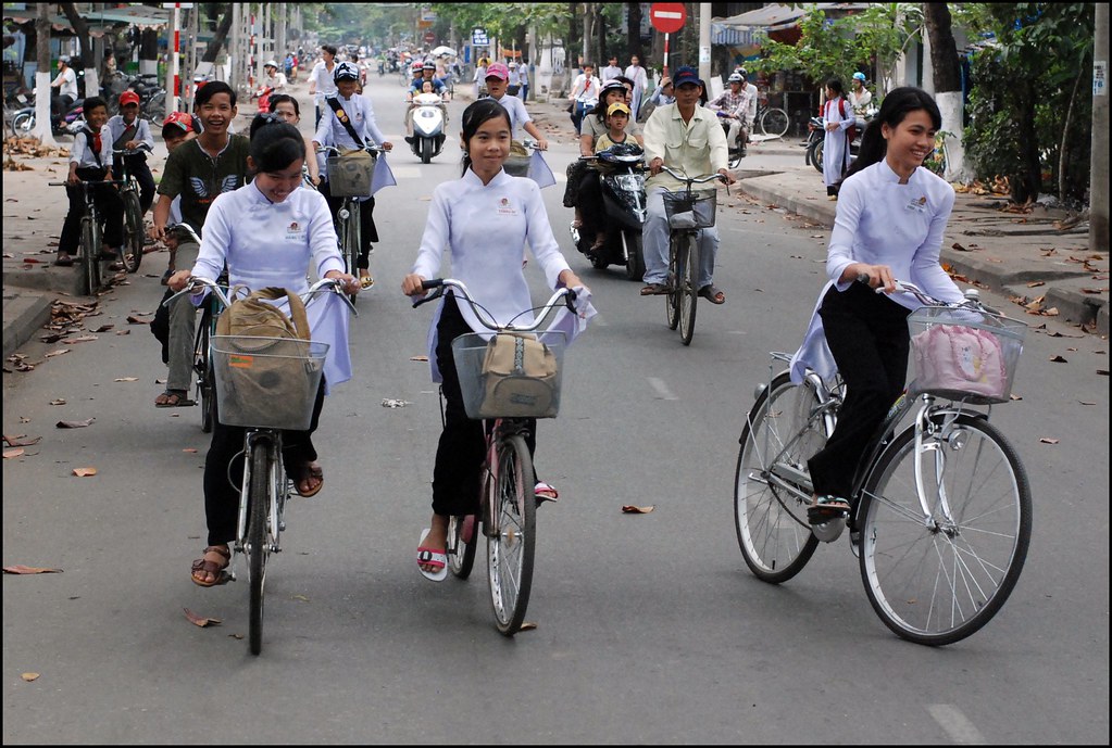 Schoolgirls on bikes on their way to school in Vietnam.