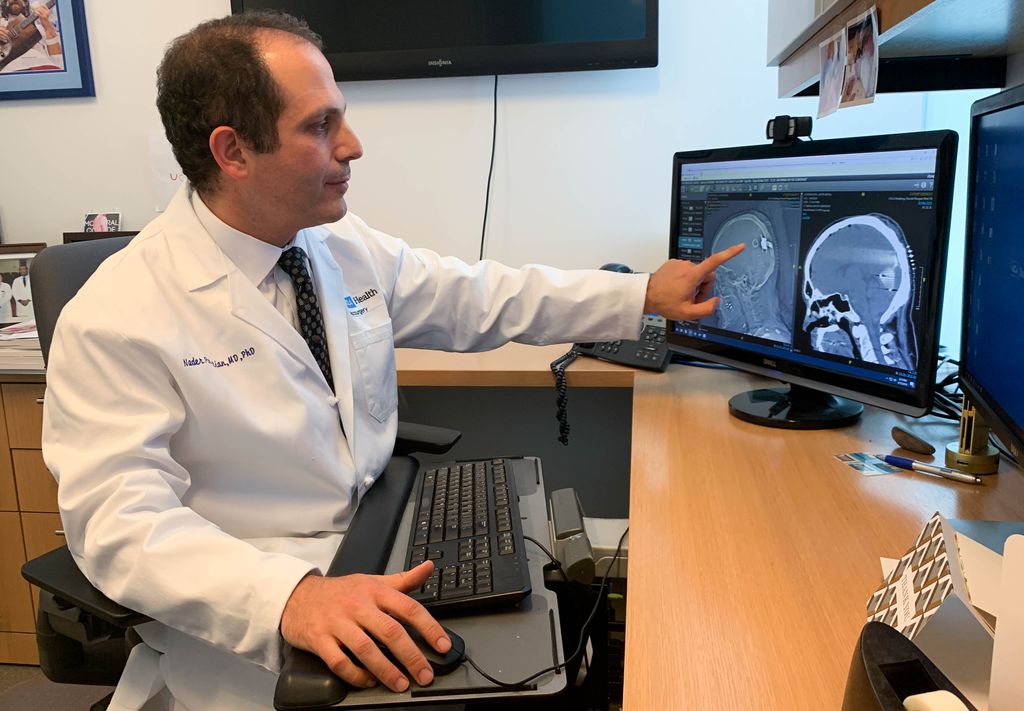 UCLA Health neurosurgeon Dr. Nader Pouratian points to an experimental device in the brain.