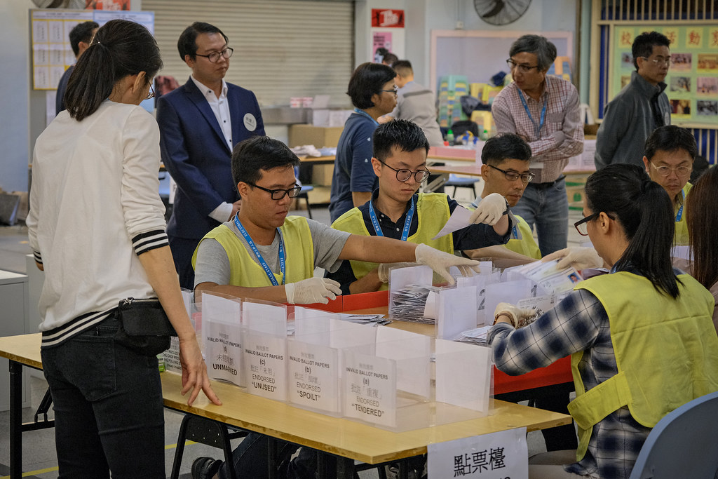 Workers counting votes in Hong Kong.