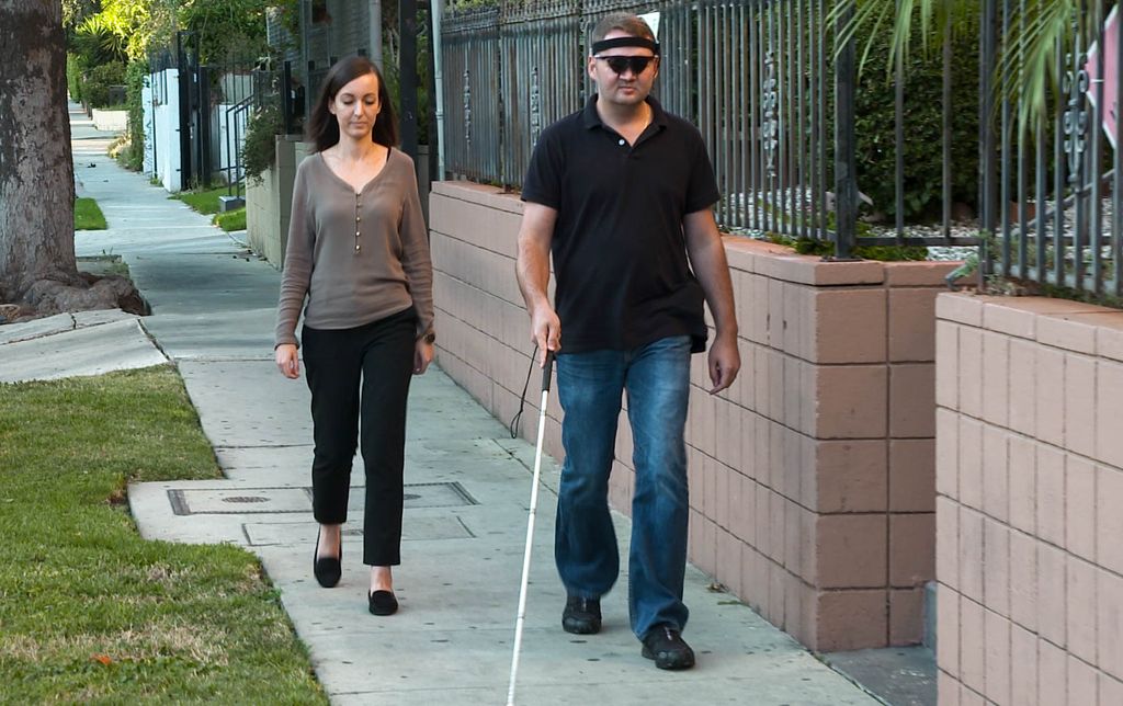 Jason Esterhuizen walks near his Los Angeles home with his wife, Sumarie.