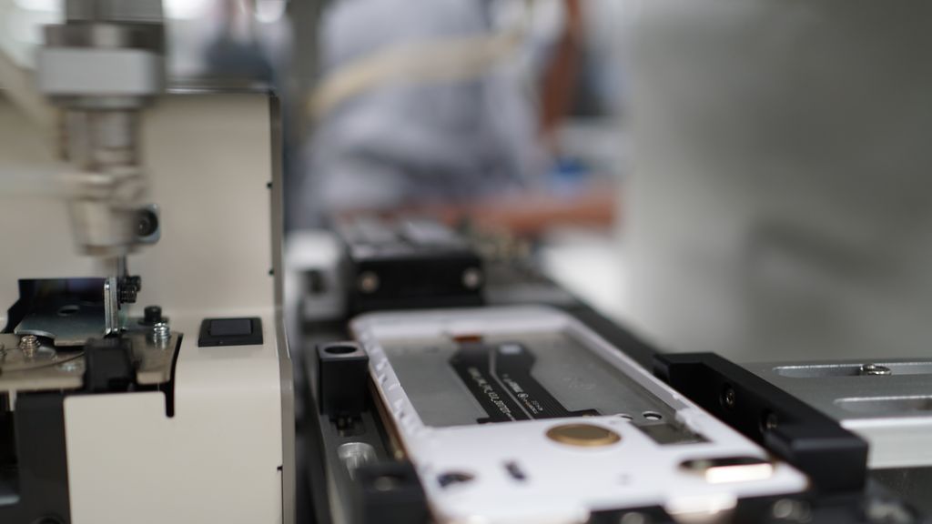 Closeup on a phone body on a production line.