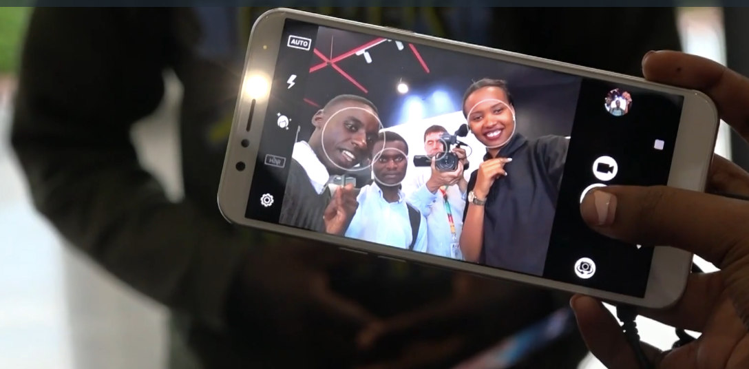 Shoppers test the selfie feature of the Mara phone.