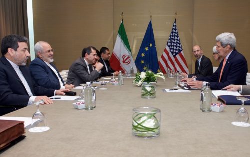 U.S. Secretary of State John Kerry sits across from Iranian Foreign Minister Javad Zarif as they settle into a meeting room in Geneva, Switzerland, on May 30, 2015, for the latest round in the P5+1 negotiations about the future of Iran's nuclear program. [State Department Photo/ Public Domain]