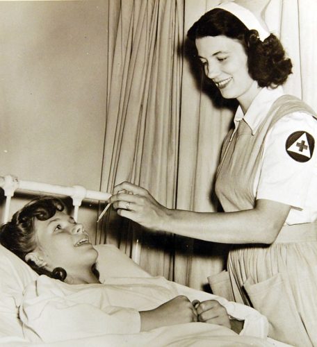 Jane Womach, nurse’s aide, take temperature of young Audrey Welch at Georgetown University Hospital, Washington, D.C.