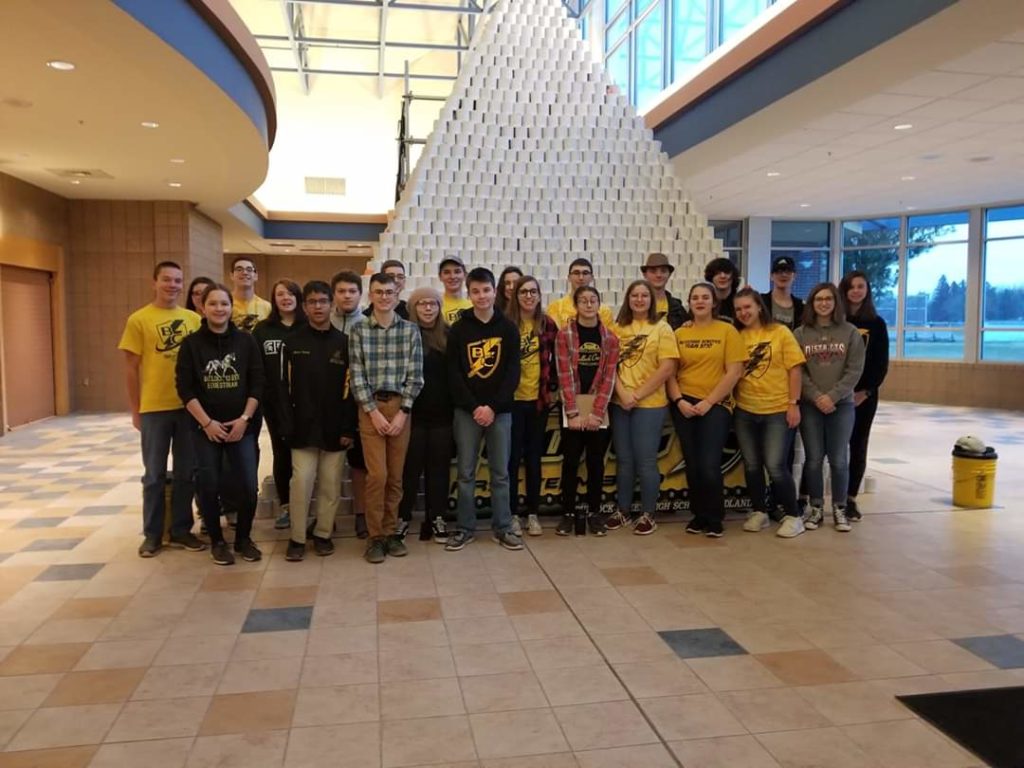 Members of the BlitzCreek 3770 Robotics team stand in front of the toilet paper pyramid.