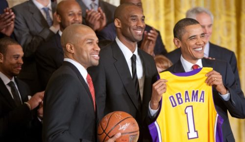 President Barack Obama holds a personalized team jersey presented to him by Los Angeles Lakers guards Kobe Bryant, center, and Derek Fisher, left, during a ceremony in the East Room of the White House honoring the 2009 NBA basketball champions, Jan. 25, 2010.