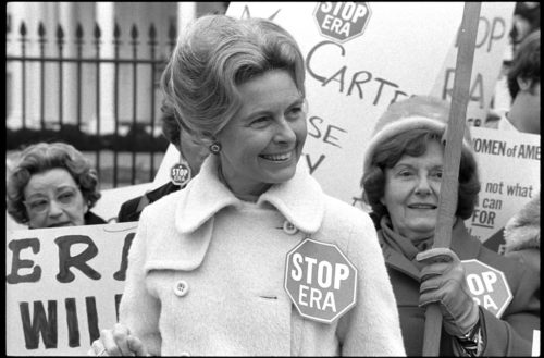 Activist Phyllis Schlafly wearing a "Stop ERA" badge, demonstrating with other women against the Equal Rights Amendment in front of the White House, Washington, D.C., February 4, 1977.
